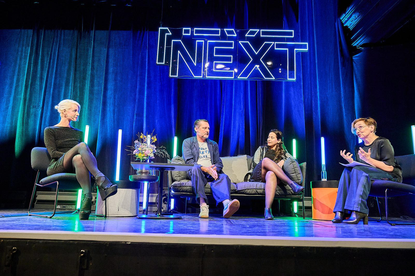 Monique van Dusseldorp moderating a four-person panel at NEXT Conference